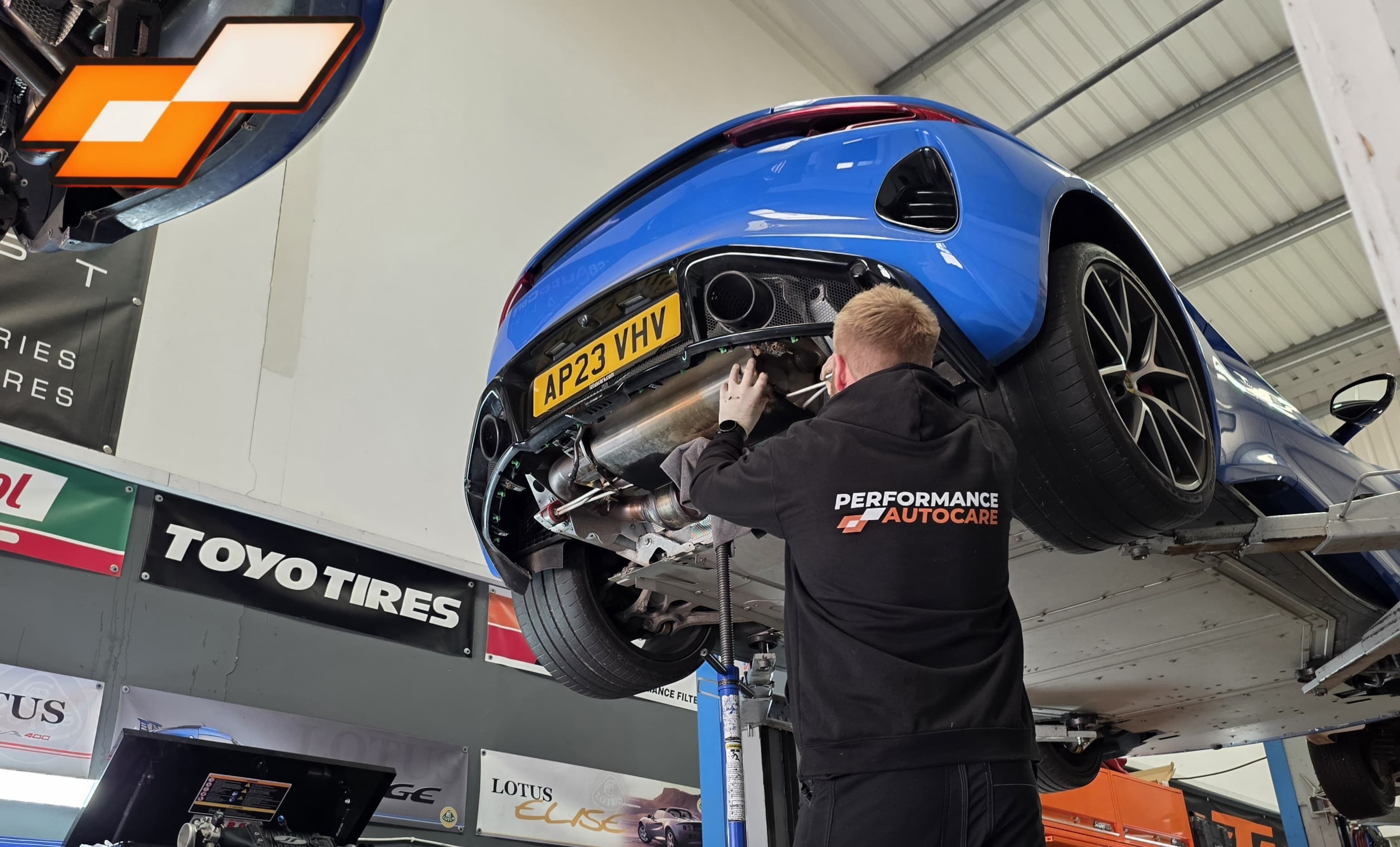 Owner Jonny fitting a custom exhaust to V6 Emira