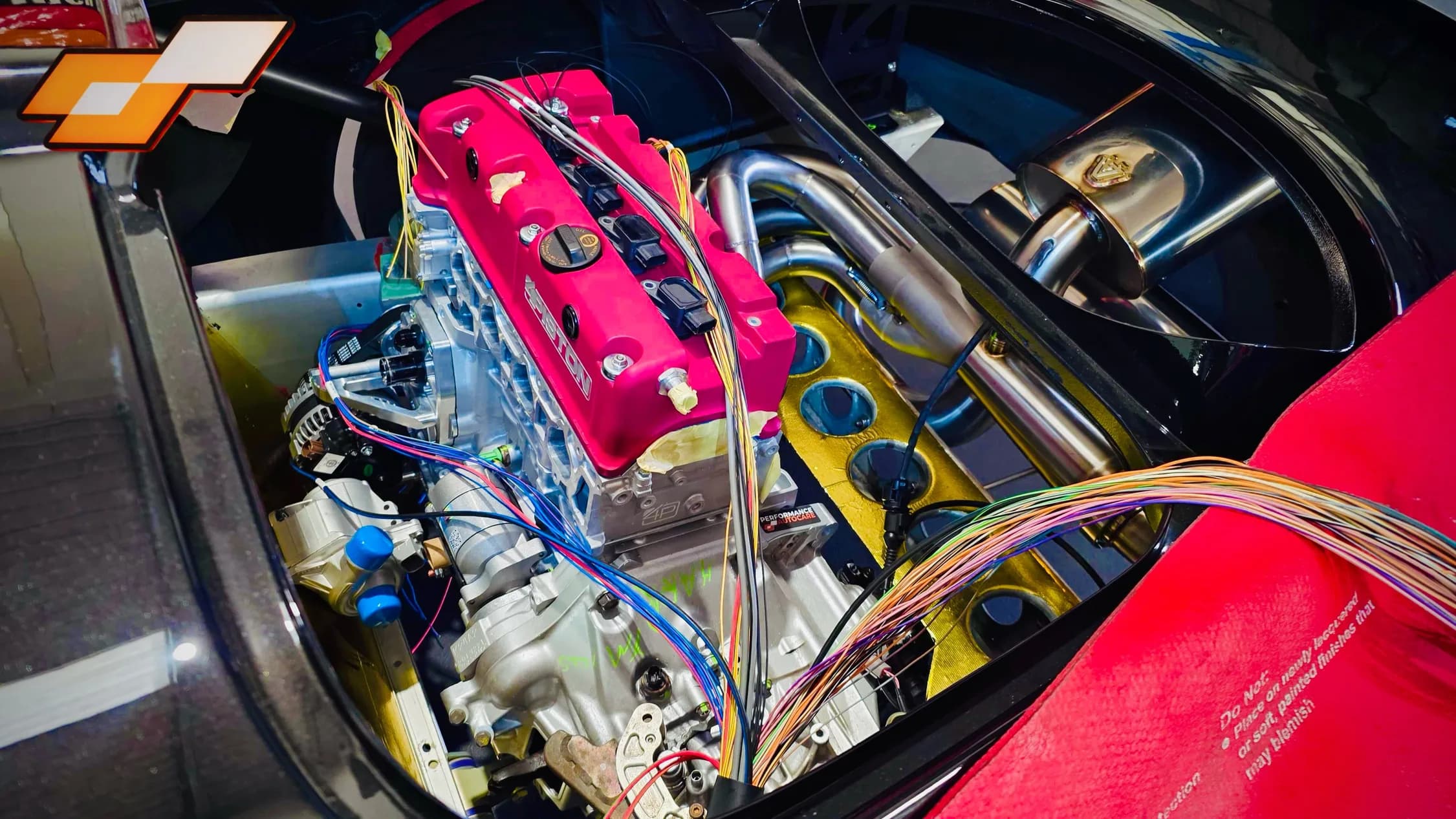 4 Piston Racing Honda K-series engine being wired into the Elige K-swap, with the custom exhaust behind
