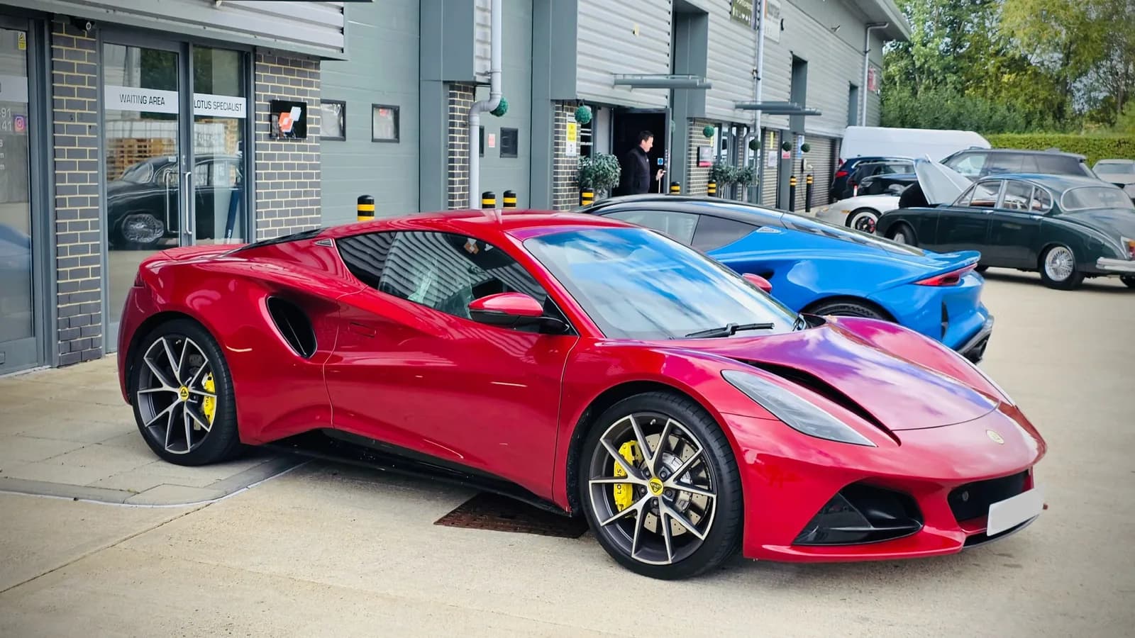 Red Lotus Emira outside Performance Autocare